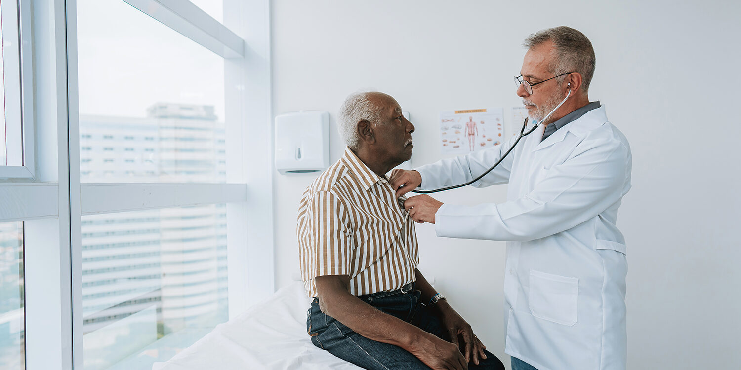 Portrait of a doctor listening to a patient’s heartbeat The Role of Heart Specialists in Managing Heart Disease